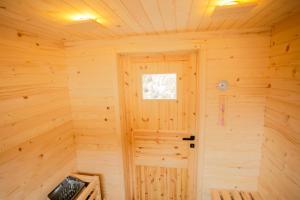 a wooden room with a door in a log cabin at MY TIME Holiday House with sauna in Zgornje Gorje