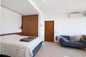 - une chambre avec un lit et un canapé dans l'établissement Casa Alameda, à Faro