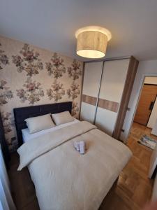 a bedroom with a bed with two candles on it at Moments Banja Luka in Banja Luka