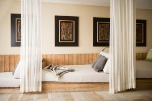 A bed or beds in a room at Falkensteiner Hotel & Spa Sonnenparadies