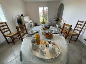 a dining room table with a plate of food on it at Chez evelyne et titou in Bordères