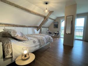 a bedroom with a bed with a candle on a table at Chez evelyne et titou in Bordères