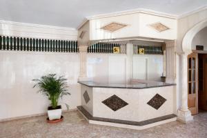 a lobby with a counter with a potted plant at Calle Manuel Mena 4 in Benalmádena +13 photos