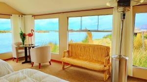 a bedroom with a room with a view of the water at Uros Maya Lodge in Puno
