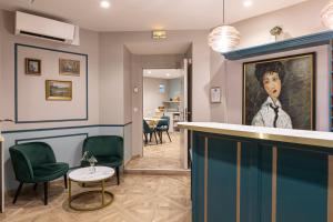a bar in a room with a painting of a man at Splendid Hôtel in Paris +59 photos