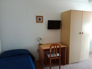 a bedroom with a desk and a bed and a cabinet at Villa di Pietro in Pescara