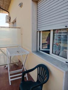 een stoel en een tafel en een raam op een balkon bij Villa di Pietro in Pescara