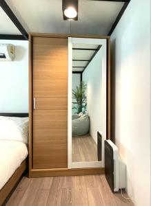 a bedroom with a door leading into a bedroom at Peaceful & Contemporary Duplex Escape in Ban Thap Nang