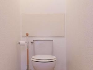 a white toilet in a bathroom with a toilet paper dispenser at Appartement Briançon, 3 pièces, 4 personnes - FR-1-330C-10 in Briançon