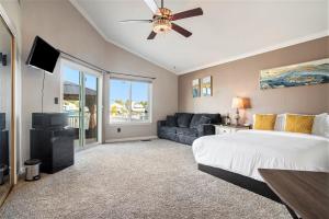 a bedroom with a bed and a couch at Lakefront Gem: Private Dock in Discovery Bay