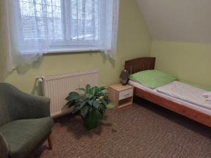 A bed or beds in a room at Penzion Raj