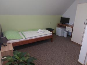 A bed or beds in a room at Penzion Raj