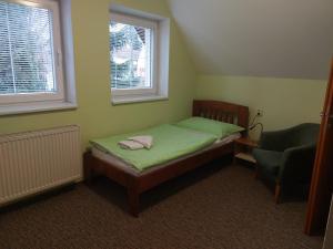 A bed or beds in a room at Penzion Raj
