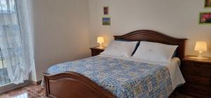 ein Schlafzimmer mit einem Bett mit zwei Lampen und einem Fenster in der Unterkunft La vie en rose flat in Sestri Levante