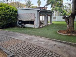a gazebo with a tent in a yard at Streetview Suites in Polokwane +18 photos