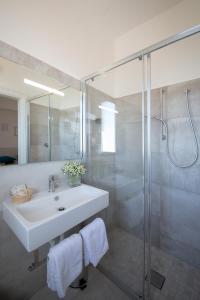 a bathroom with a sink and a shower at Hotel Sole in Cattolica