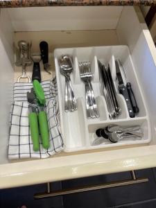 a white tray filled with utensils in a drawer at Jomtien Condotel Condominium in Pattaya South
