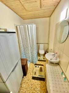 a small bathroom with a sink and a toilet at Saint Nicholas heights in Chakistra