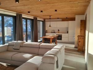 a living room with a couch and a table at Casa Lo Tzé Relais - Indipendent house with amazing view in Valtournenche