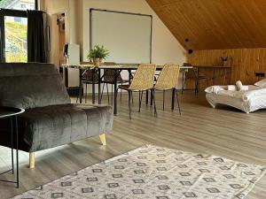 Gorczańskie Zacisze في Lubomierz: غرفة معيشة مع أريكة وطاولة وكراسي
