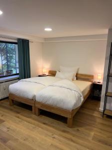 a bedroom with a bed and a large window at Casa Materi Poppenhausen in Poppenhausen