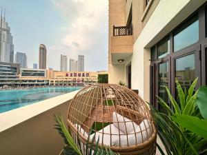 jaula de aves sentada en un balcón junto a una piscina en Durrani Homes - Heaven On Earth- Burj Khalifa Fireworks en Dubái