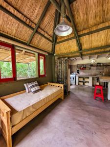 a bedroom with a large bed in the middle of a room at La Saucina - Cabaña Rústica Chic in Tunuyán