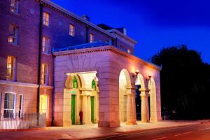 a building with green lights on the side of it at University Arms, Autograph Collection in Cambridge