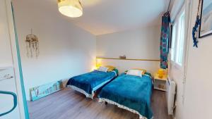 Ένα ή περισσότερα κρεβάτια σε δωμάτιο στο La Mer a vos Pied pour 4 personnes