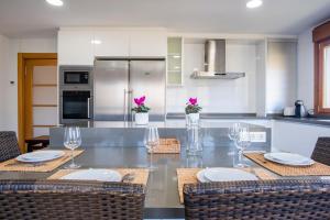 a kitchen with a table with chairs and wine glasses at Apartamentos Cangas Relax En Grupo in Cangas de Onís +21 photos