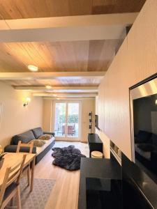 a living room with a couch and a table at Le Petit Chalet Limone in Limone Piemonte