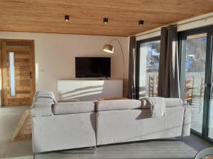 a living room with a couch and a tv at Casa Lo Tzé Relais - Indipendent house with amazing view in Valtournenche