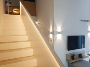 a staircase in a house with a tv on the wall at MAS CATXINA Hotel Boutique 4 estrellas in Deltebre