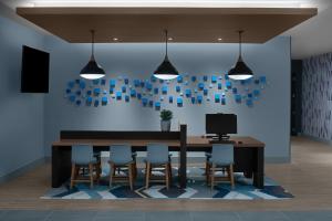 a dining room with a table and chairs at Hyatt House Lansing-University Area in Lansing