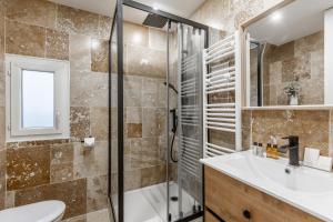 a bathroom with a shower and a sink and a toilet at Sweett - Troyon in Paris