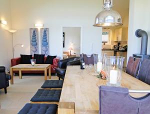 a dining room with a table and a living room at Leuchtturm in Bohnert +14 photos