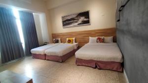 Postel nebo postele na pokoji v ubytování Rainbow Hotel