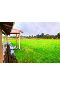 a view of a large field with a pavilion at El Tambo del Anakiri in Los Muermos