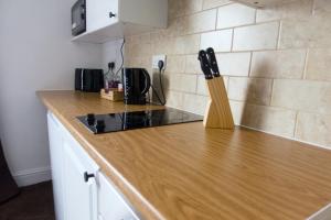 a kitchen counter with a knife block on it at Studio apartment - The Topaz 