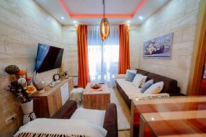 a living room with a couch and a tv at Zlatibor Vila Peković Green S4 in Zlatibor