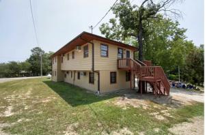 a house with a staircase in a yard at Driftwood Resort Bull Shoals in Bull Shoals