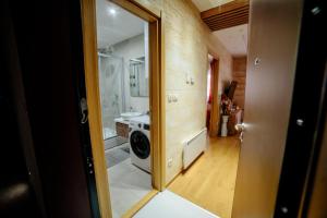 a bathroom with a washer and dryer in a room at Zlatibor Vila Peković Green S4 in Zlatibor +8 photos