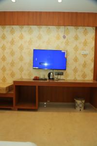 a flat screen tv sitting on top of a desk at Hotel Sai D-lax in Shirdi