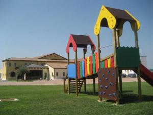 a playground with a slide in a park at Seiterre Agriturismo Tenuta San Leone in Valeggio sul Mincio