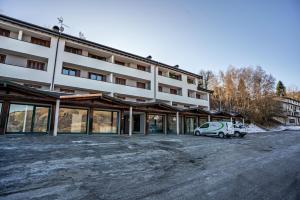 a white car parked in front of a building at Appartamento Polsa 4 in Brentonico