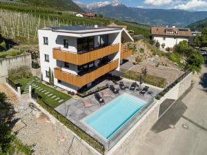 an aerial view of a house with a swimming pool at Köfele Lodge Sepp in Parcines