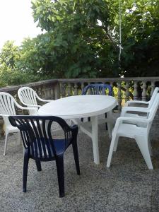 a white table and chairs next to a fence at Holiday Home Pavica in Vrsi