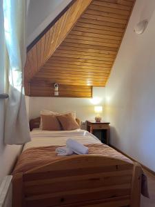 a bedroom with a large bed with a wooden ceiling at Kraljevi konaci Helena in Zlatibor