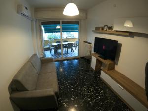 a living room with a couch and a television at Victor House by PortofinoVacanze in Santa Margherita Ligure