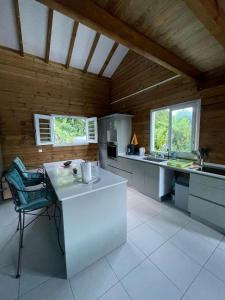 a large kitchen with a white counter in a room at VILLA -Le Chalet Tropical in Le Marin